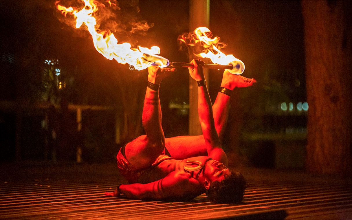 Fire dancer performing at Moana Luau, Hawaii.