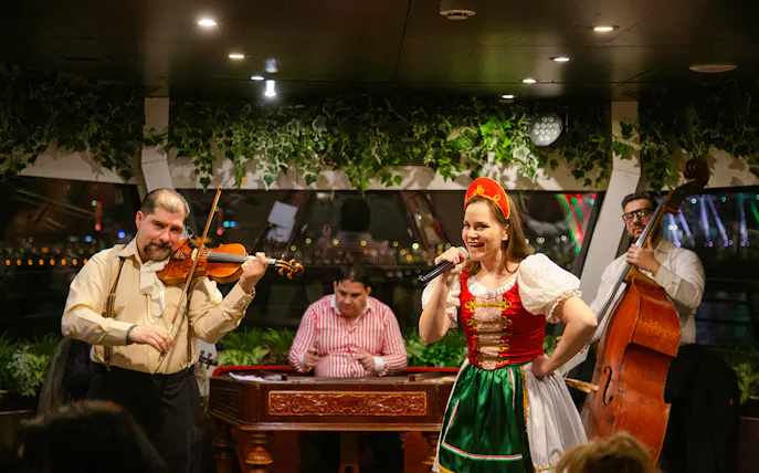 Musicians and singer performing during Budapest Dinner Cruise with Folklore Show.