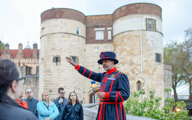 Beefeater guiding a group at the Tower of London during the VIP after-hours tour.
