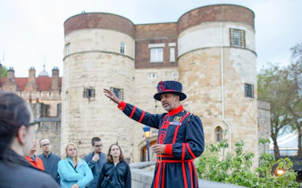 Beefeater guiding a group at the Tower of London during the VIP after-hours tour.