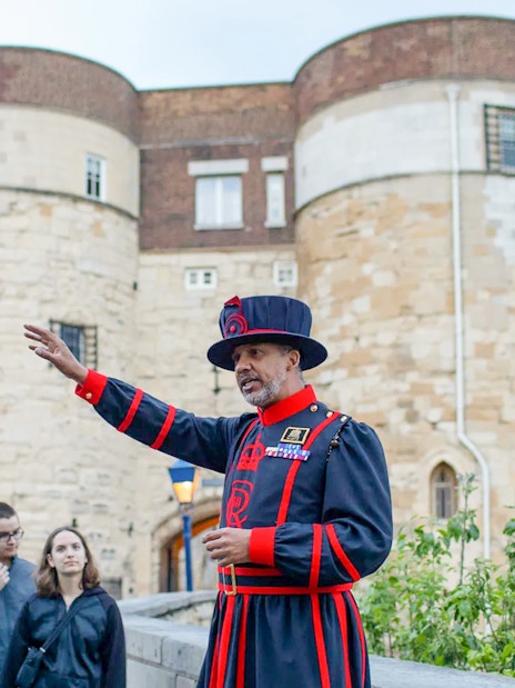 Beefeater guiding a group at the Tower of London during the VIP after-hours tour.