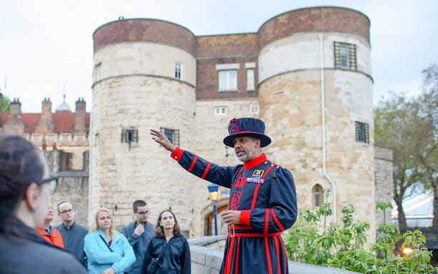 Beefeater guiding a group at the Tower of London during the VIP after-hours tour.