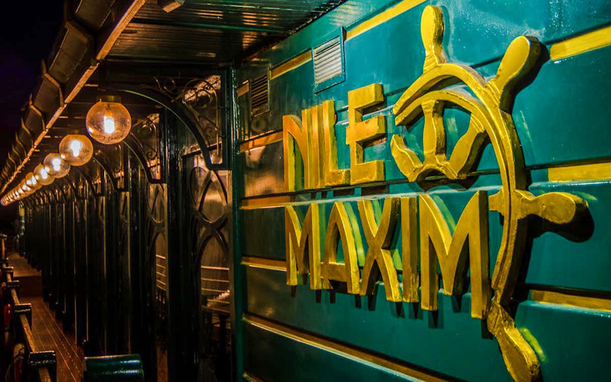 Nile Maxim logo on luxury dinner cruise ship deck.