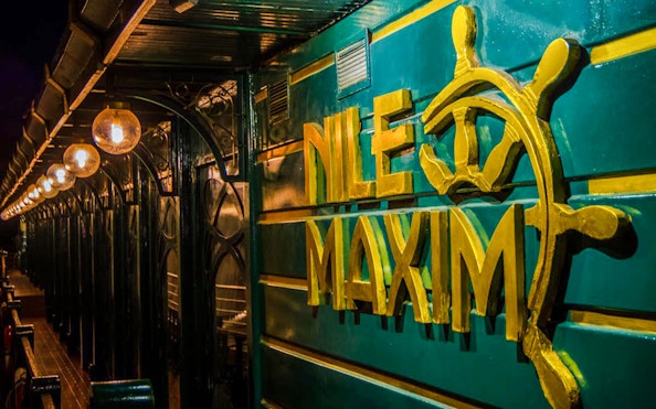 Nile Maxim logo on luxury dinner cruise ship deck.