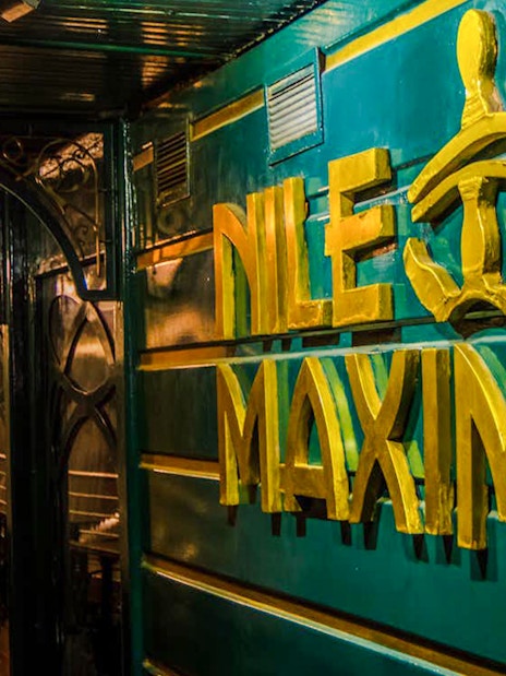 Nile Maxim logo on luxury dinner cruise ship deck.