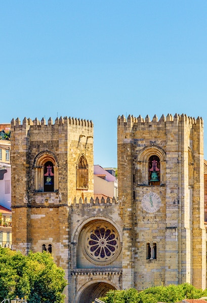 Lisbon Cathedral twin towers with rose window and clock face.