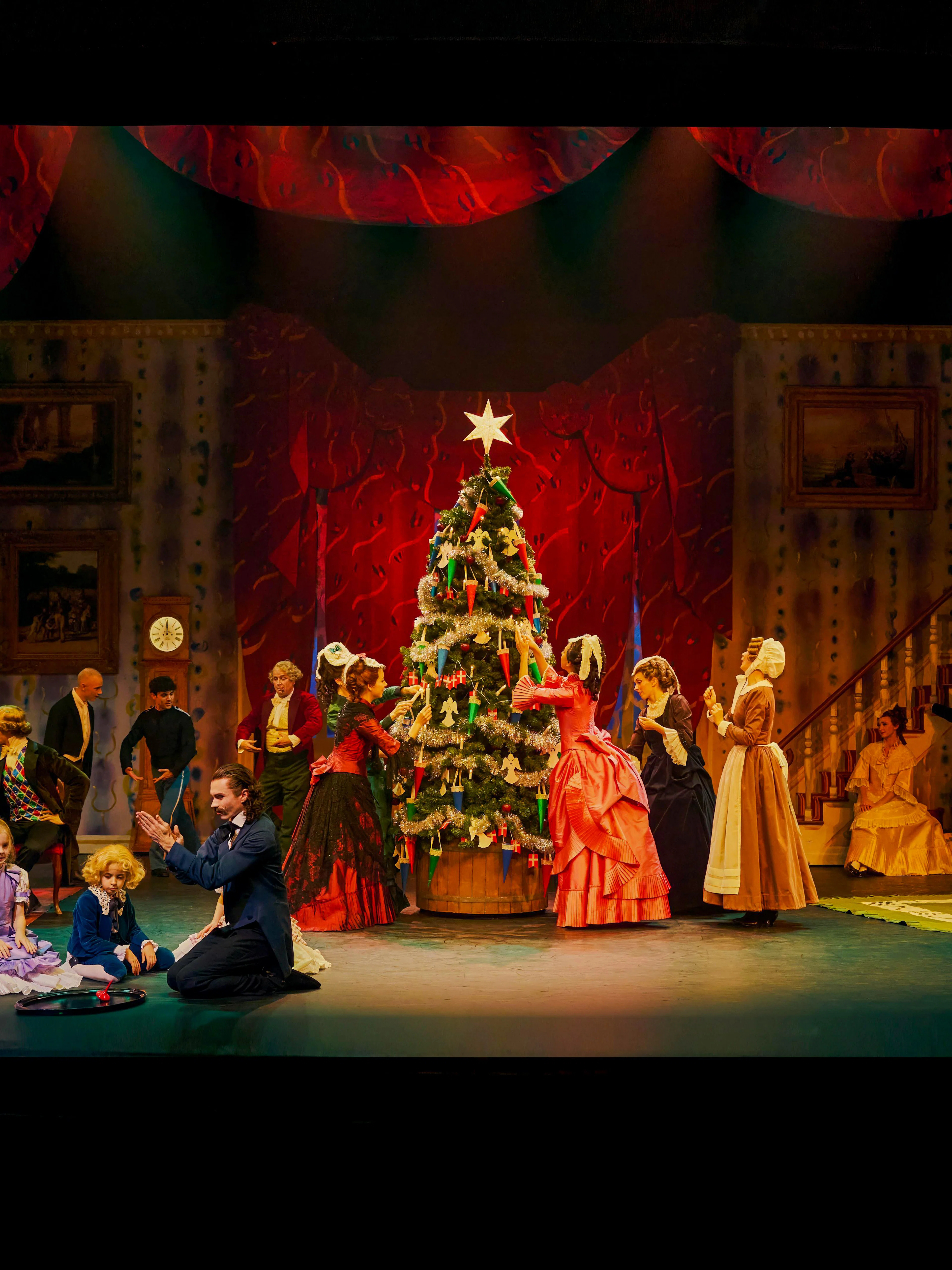 Performers in period costumes around a Christmas tree during The Nutcracker show at Tivoli Gardens.