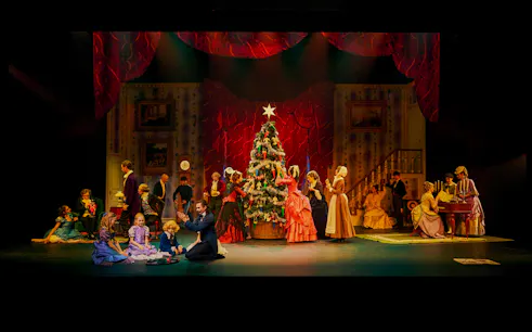 Performers in period costumes around a Christmas tree during The Nutcracker show at Tivoli Gardens.