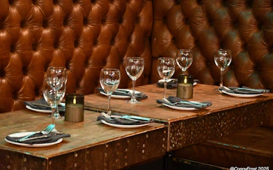 Private dining setup with glassware and candles in an exclusive Icelandic restaurant.