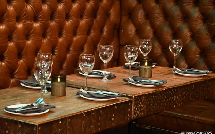 Private dining setup with glassware and candles in an exclusive Icelandic restaurant.