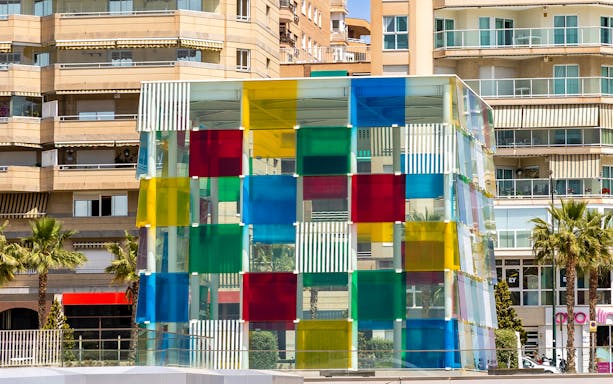Colorful glass cube structure at Malaga's Pompidou Centre.