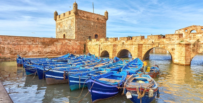 Sqala du Port tower overlooking fishing boats in Essaouira, Morocco.