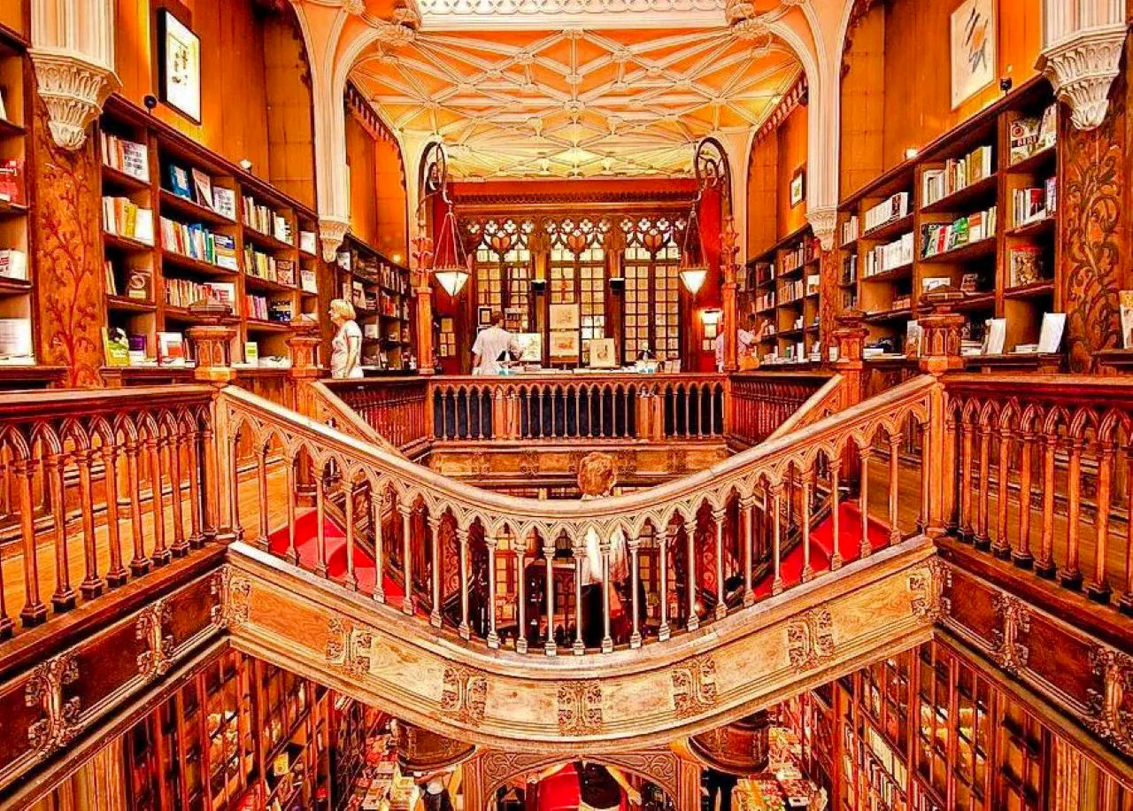 Livraria Lello's ornate wooden staircase and bookshelves, Porto.
