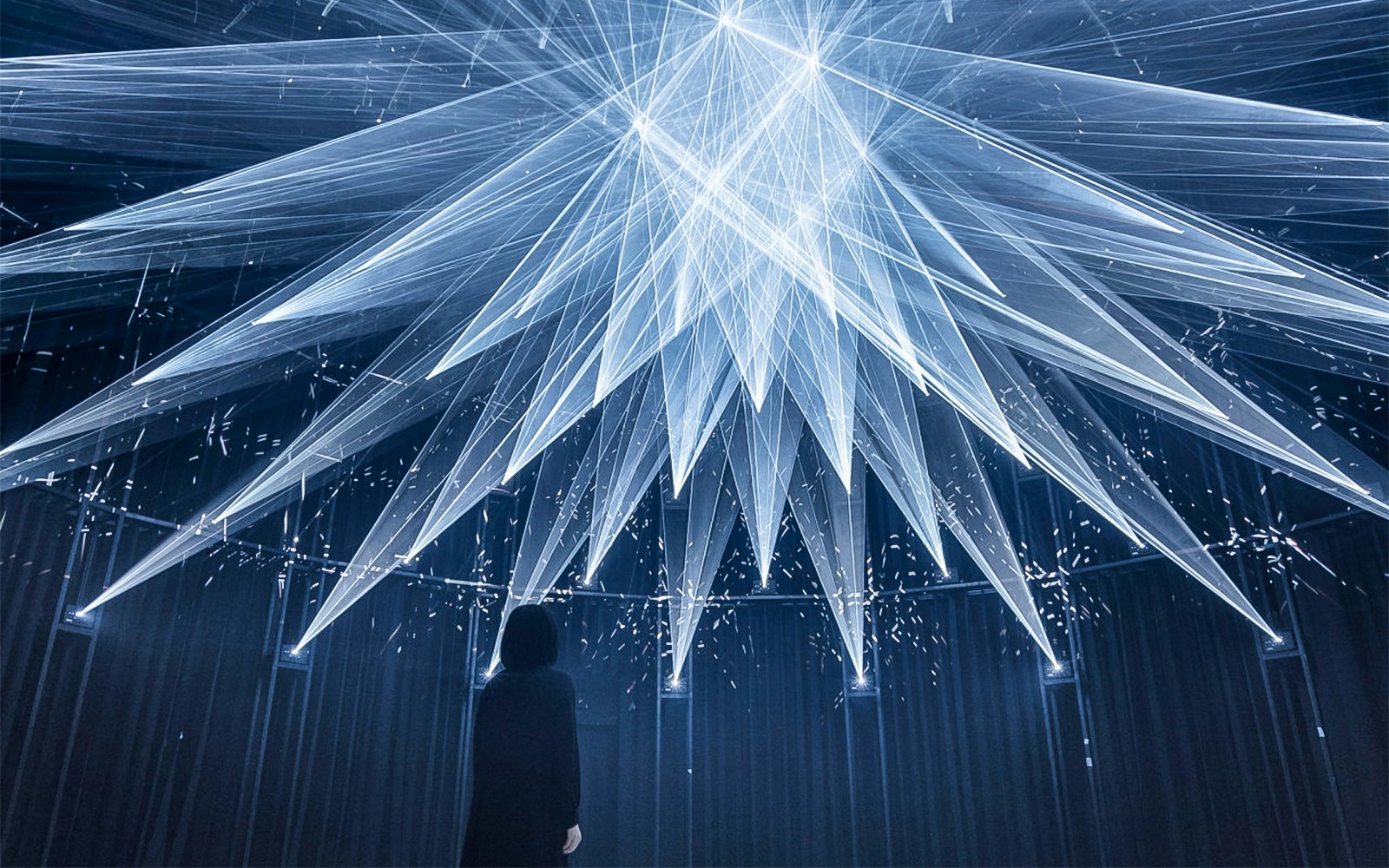 Woman exploring light show in teamLab SuperNature Macao