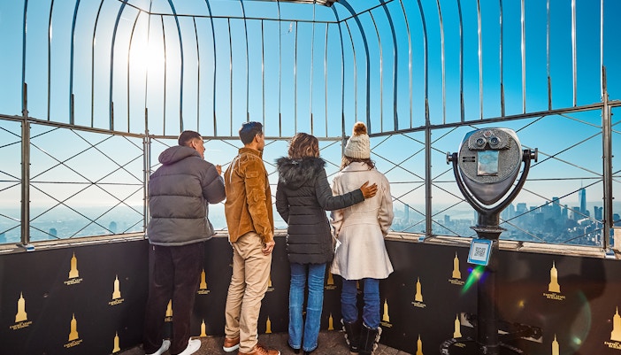 Visitors enjoying panoramic views from the 102nd and 86th Floor Observation Decks in New York City.