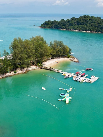 Langkawi Island Hopping tour with boats docked at a small island pier.