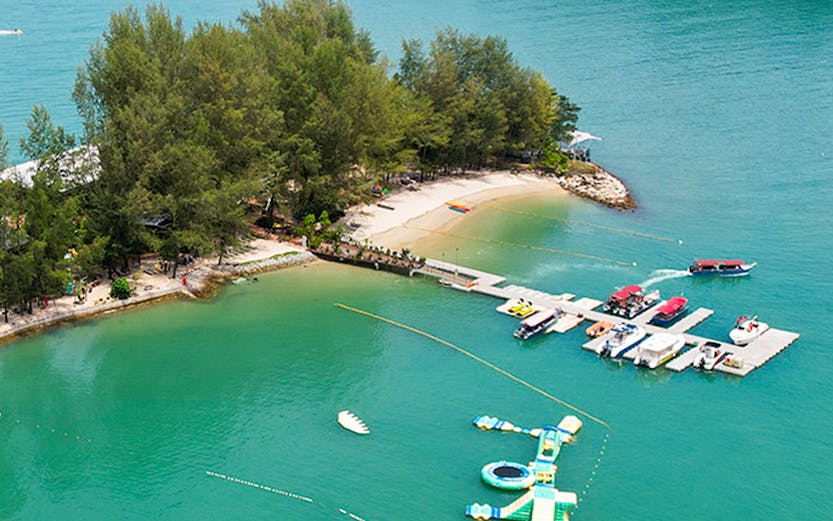 Langkawi Island Hopping tour with boats docked at a small island pier.