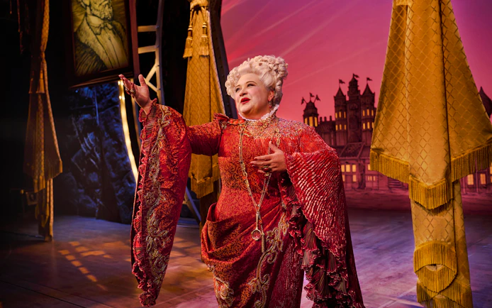 Performer in ornate costume on stage during Wicked musical.