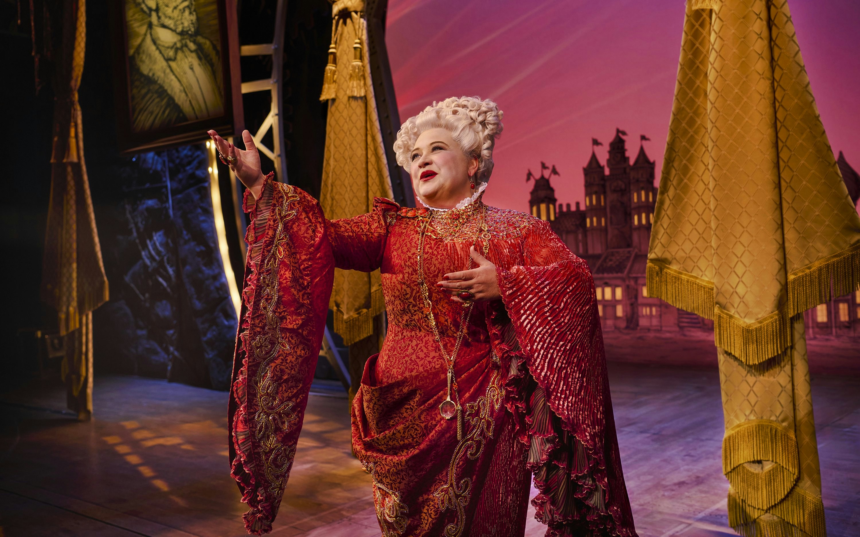 Performer in ornate costume on stage during Wicked musical.