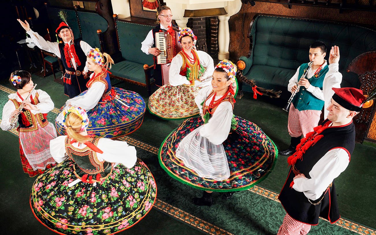 Folk dancers in traditional Polish costumes performing at Jama Michalika Cafe.