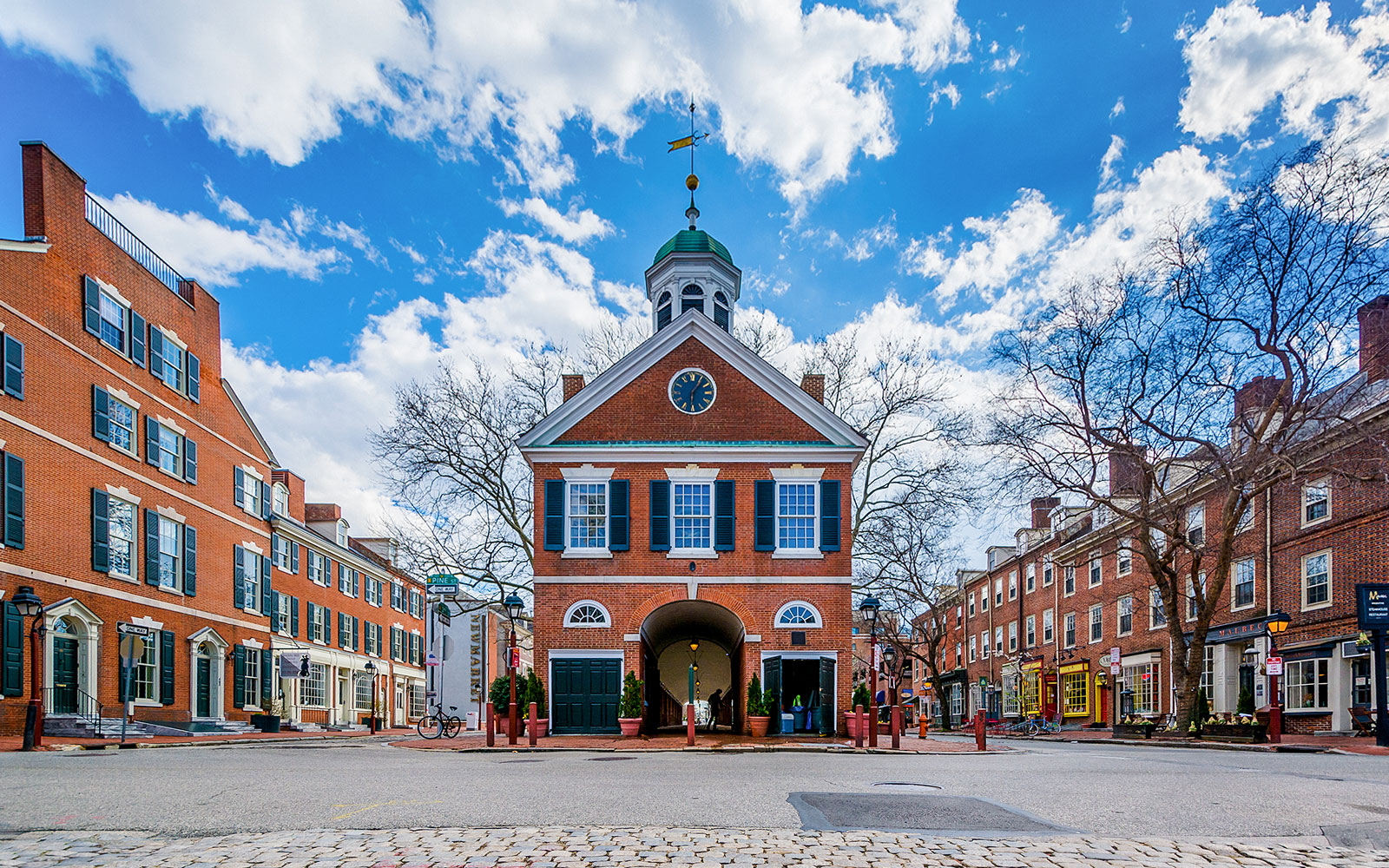 Headhouse Square in Philadelphia with historic brick buildings and cobblestone street.