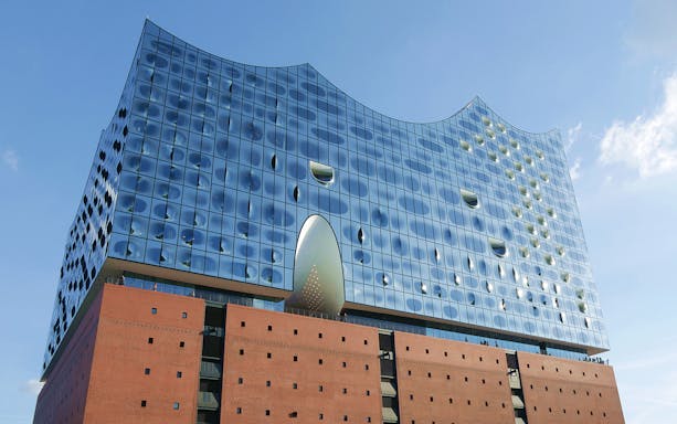 Elbphilharmonie Hamburg glass facade under blue sky.