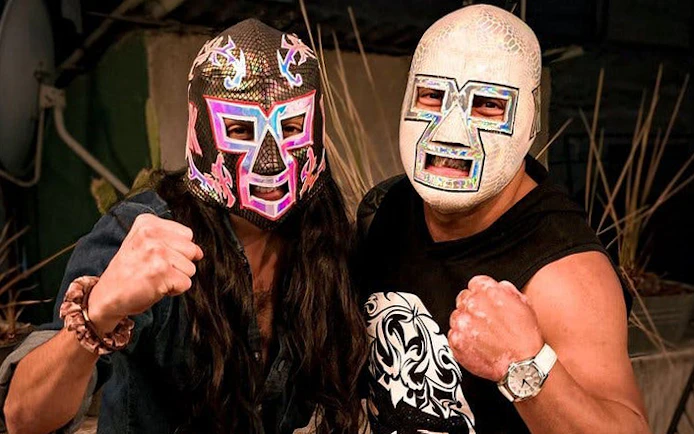 Masked wrestlers posing at a Lucha Libre event in Mexico City.