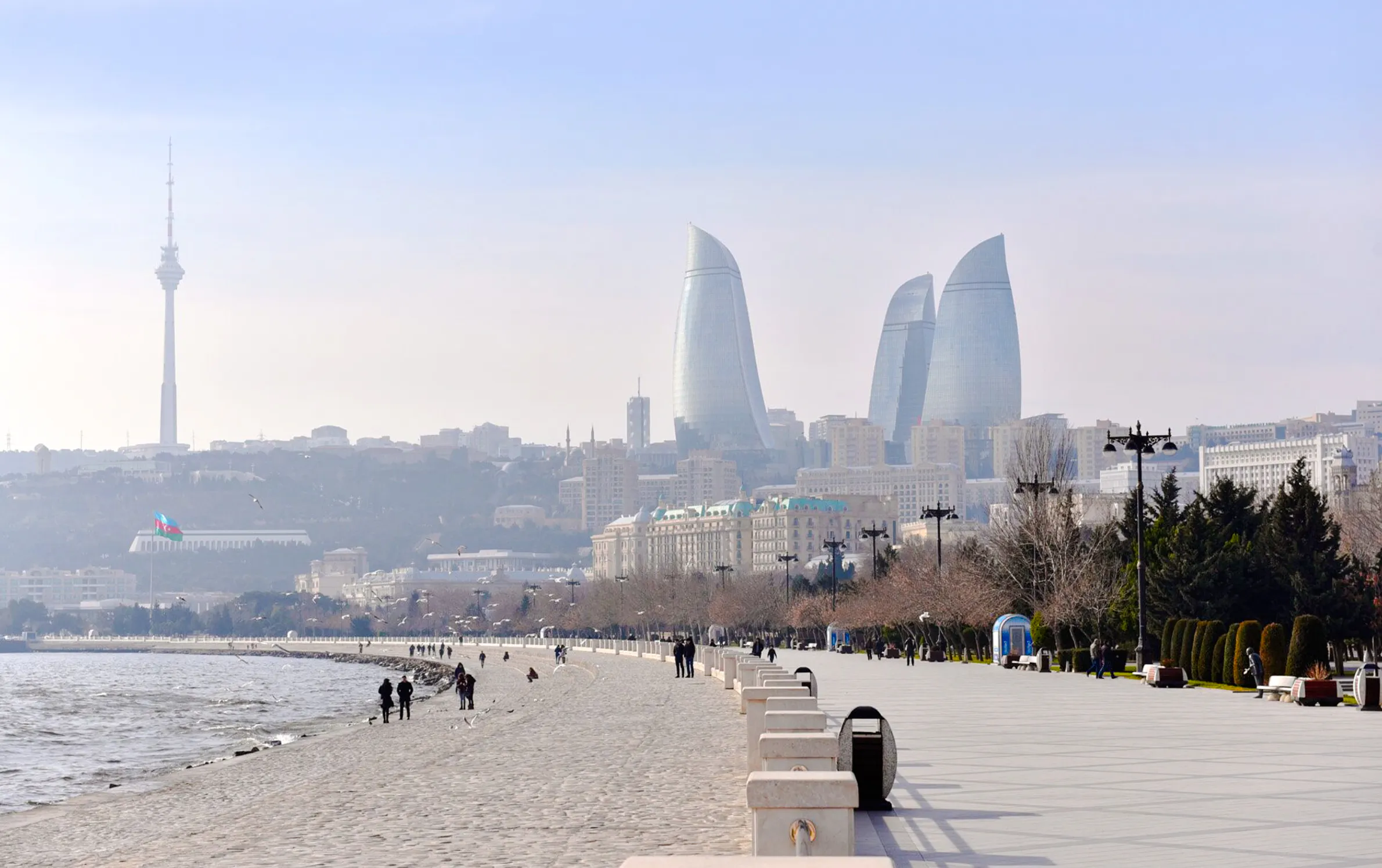 Baku cityscape with Flame Towers and Caspian Sea promenade.
