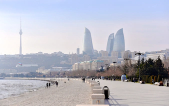 Baku cityscape with Flame Towers and Caspian Sea promenade.