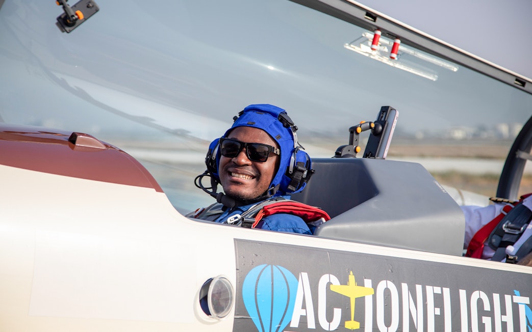 Passenger smiling in cockpit during G-FORCE Aerobatic Experience flight.