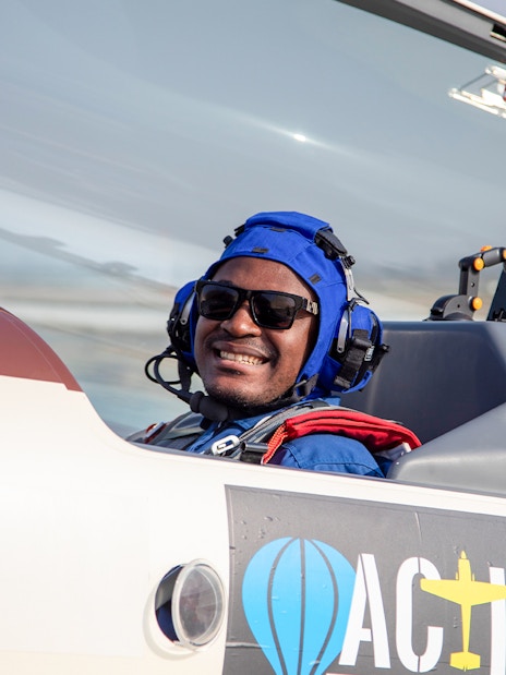 Passenger smiling in cockpit during G-FORCE Aerobatic Experience flight.