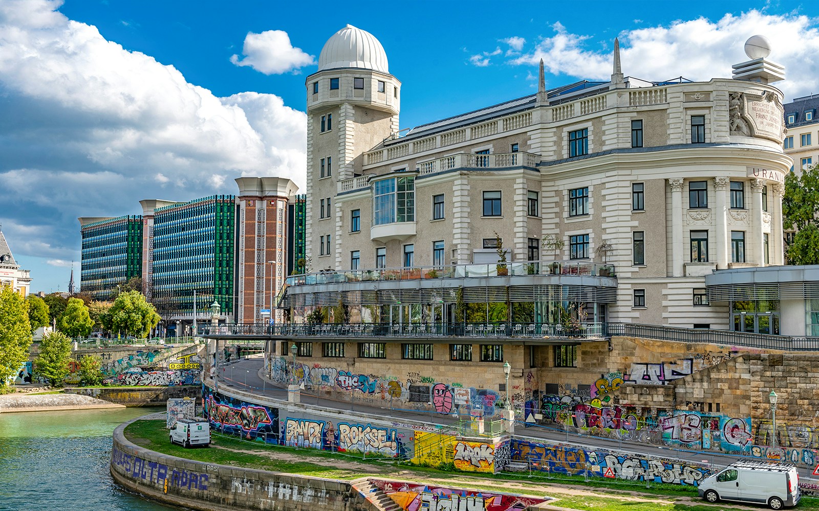 Urania observatory dome and surrounding architecture in Vienna, Austria, viewed from Danube River cruise.