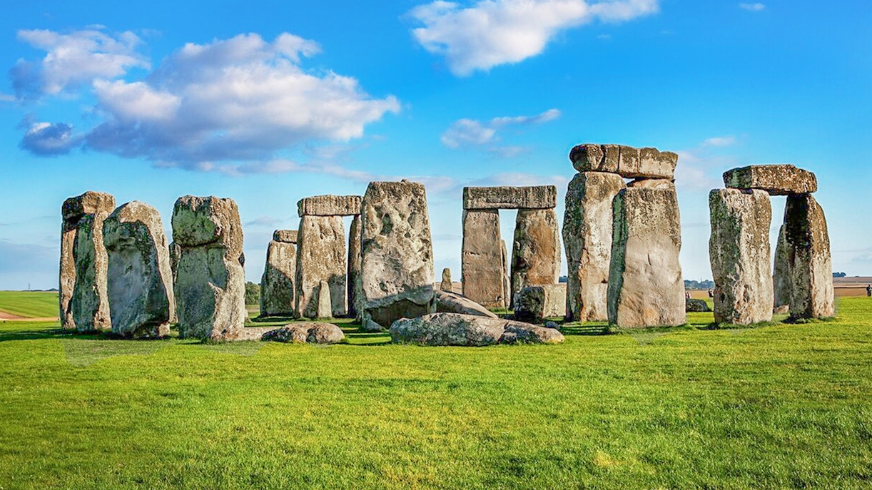 Stonehenge stone circle under blue sky on a day trip from London.