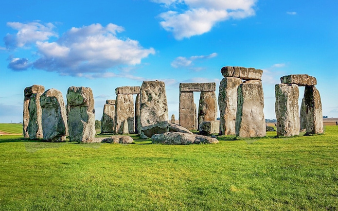 Stonehenge stone circle under blue sky on a day trip from London.