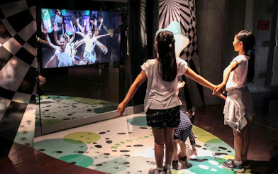 Children interacting with a digital exhibit at Okinawa Zoo & Museum.