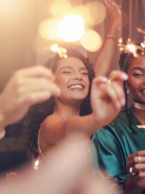 Tourists celebrating with sparklers at a lively party.