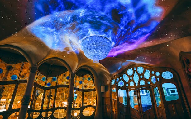 Casa Batlló interior with illuminated ceiling and stained glass windows, Barcelona.