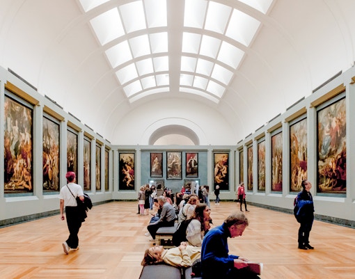 Tourists viewing the Mona Lisa at the Louvre Museum, Paris, with direct access.