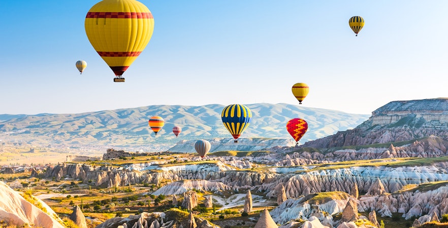 Hot air balloons over Cappadocia's unique rock formations, Turkey.