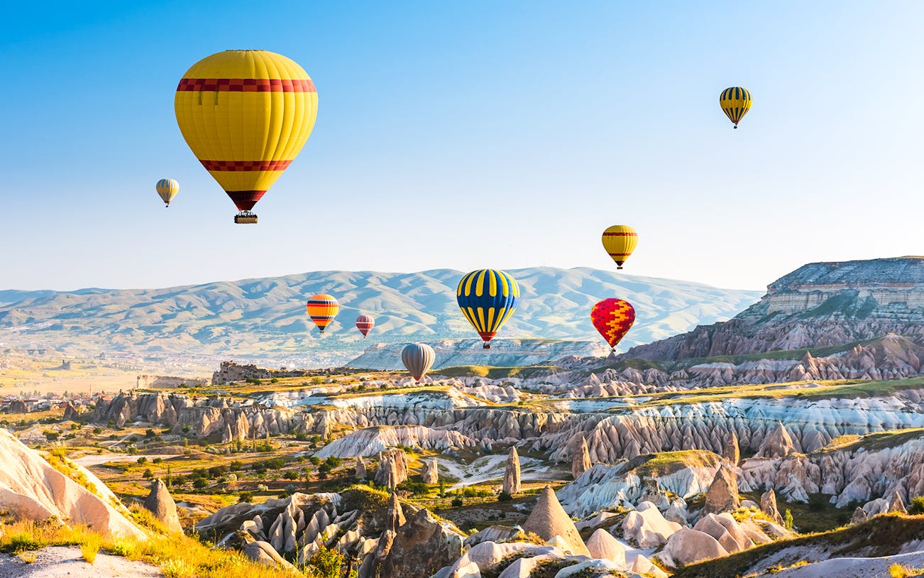 Hot air balloons over Cappadocia's unique rock formations, Turkey.