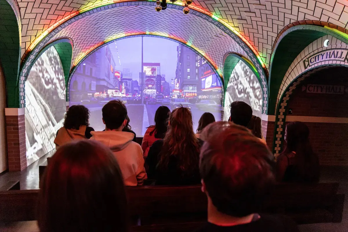 Guests watching immersive film at Rise NY showcasing New York City streets.