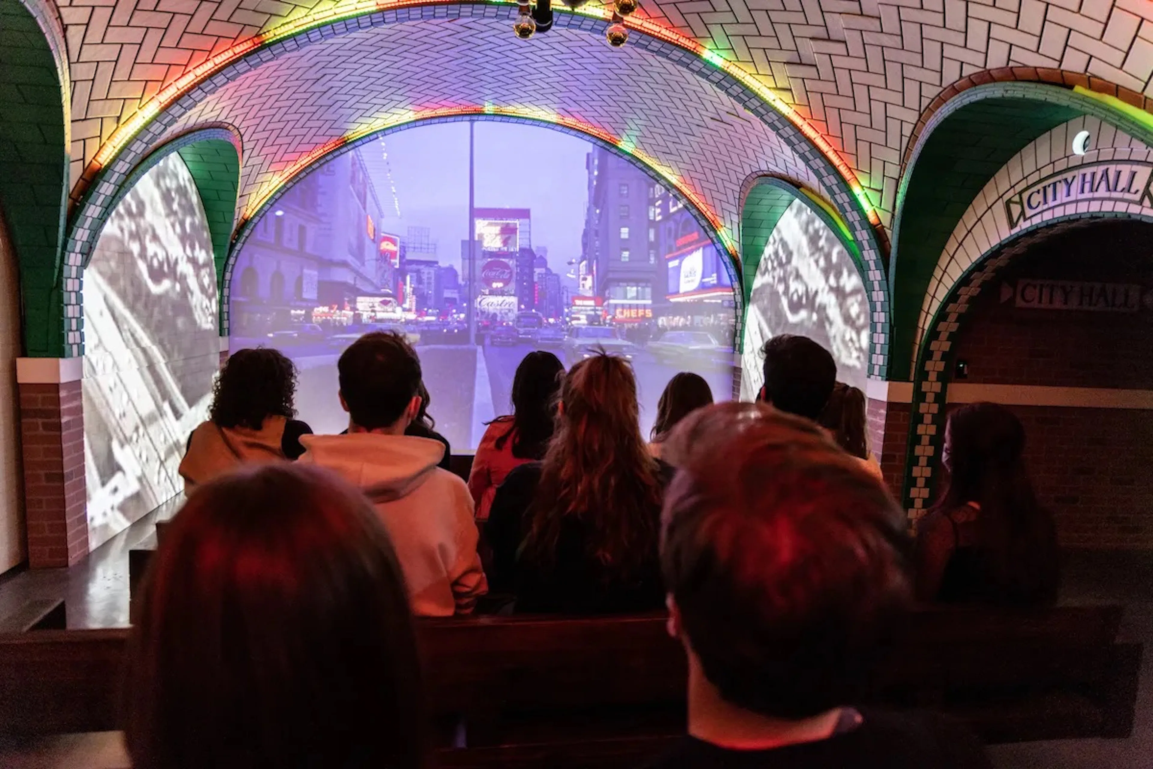 Guests watching immersive film at Rise NY showcasing New York City streets.