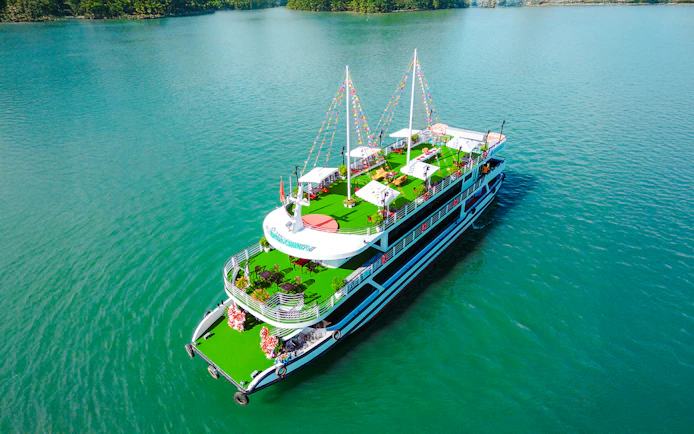 Luxury Sky Apollo Cruise 2 on turquoise water with green deck and festive decorations.