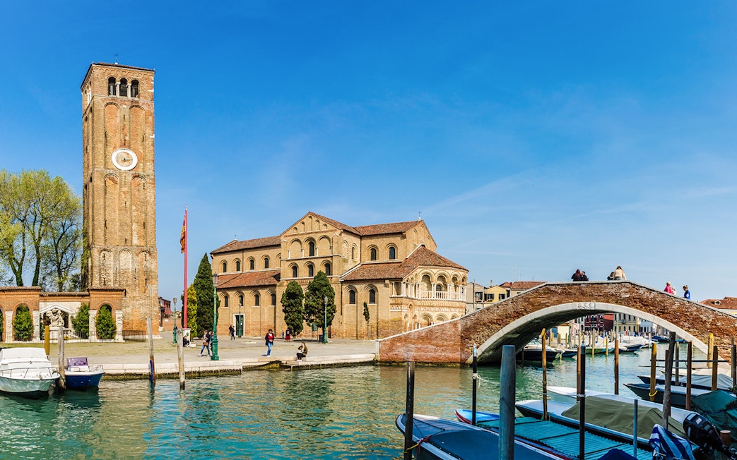 Murano Basilica dei Santi Maria e Donato with canal and boats in foreground.