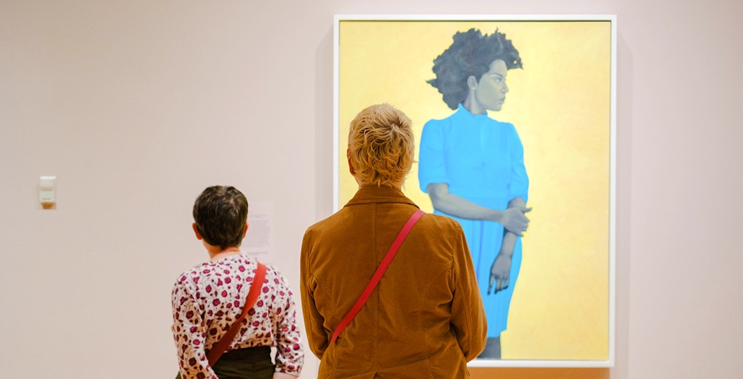 Visitors viewing artwork at Seattle Art Museum exhibition.