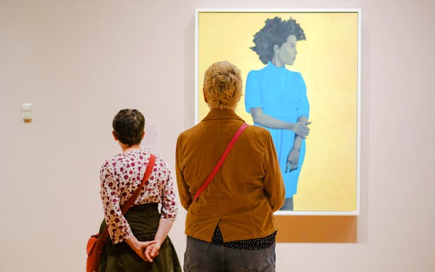 Visitors viewing artwork at Seattle Art Museum exhibition.