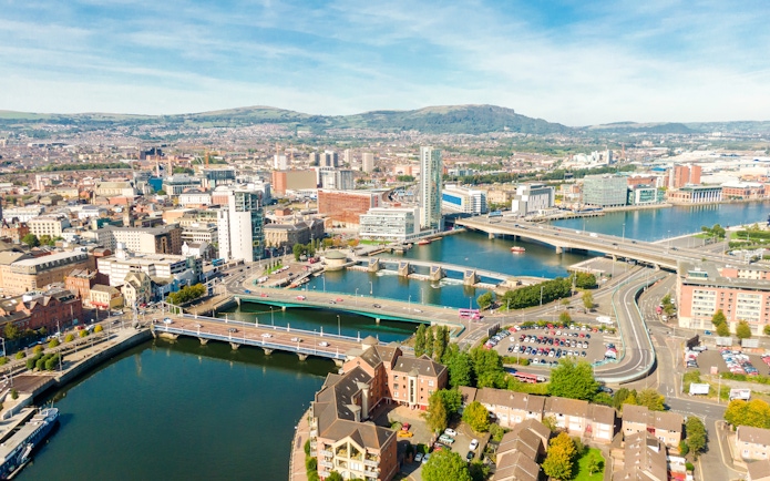 Aerial view of Belfast cityscape with bridges over the River Lagan.