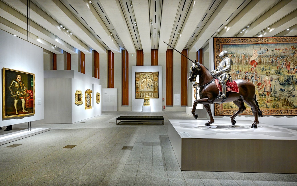 Royal Collections Gallery interior with knight statue on horseback and historical paintings.