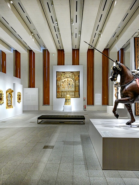 Royal Collections Gallery interior with knight statue on horseback and historical paintings.