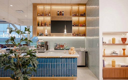 Bar area at Plaza Premium First lounge, Vancouver International Airport, featuring liquor display and seating.